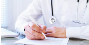 Doctor writing on a document